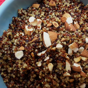 A closeup of Curried Quinoa with Toasted Almonds in a blue bowl