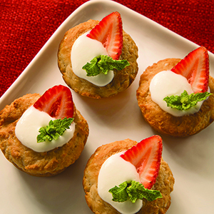 A closeup of a white ceramic platter holding several Gluten Free Strawberry Shortcakes