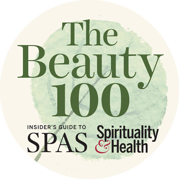 Cream colored circle logo with a watermark of a green circular leaf and the words The Beauty 100 Insider's Guide to Spas, Spirituality and Health