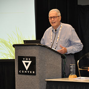 NOW Foods founder Elwood Richard speaking behind a lectern in acceptance of award