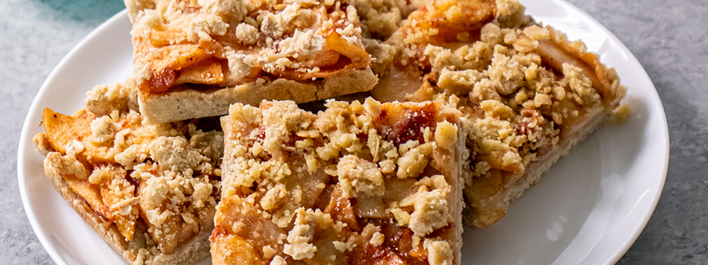 white plate with five square apple pie bars