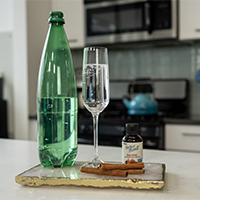 bottle of soda water, champaign glass filled with drink, and bottle of Chia BetterStevia 