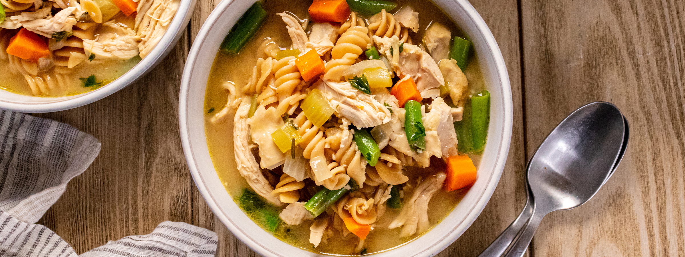 top view of bowl of chicken vegetable noodle soup