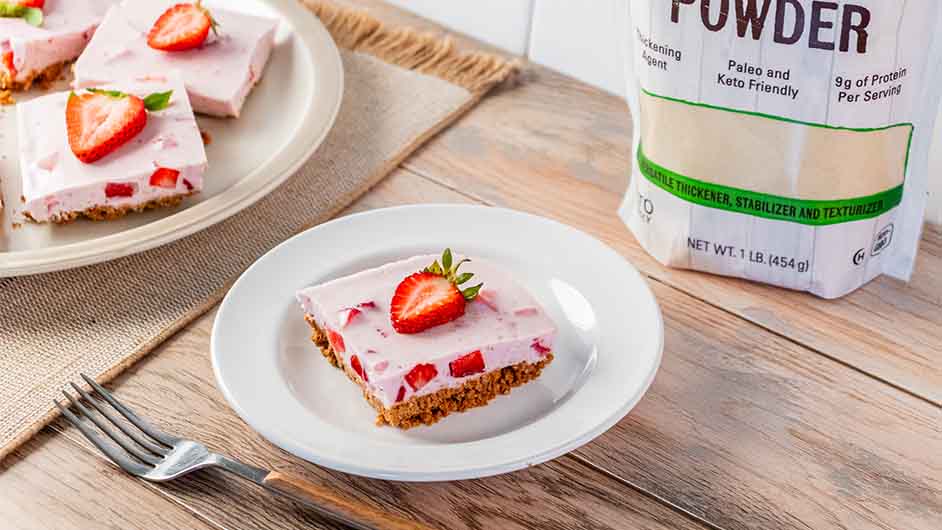 top view of two white plates containing No-Bake Strawberry Gelatin Dessert on a wooden table with a fork