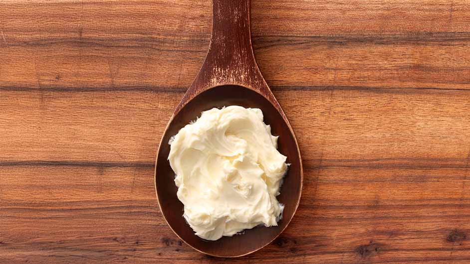 A wooden spoon of sugar cookie body butter