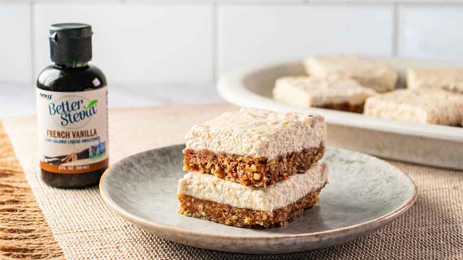 gray plate containing two Vegan No-Bake Cheesecake Bars stacked on top of each other next to NOW Monk Fruit Vanilla