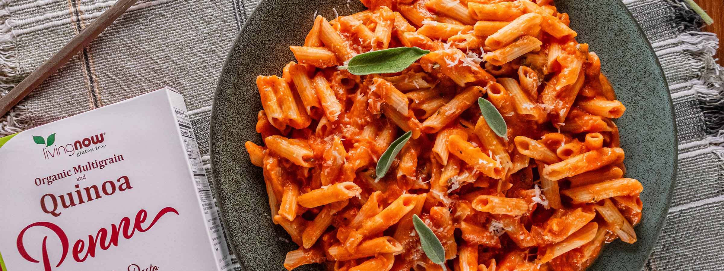 top view of Pumpkin Penne with Sage next to a box NOW Penne