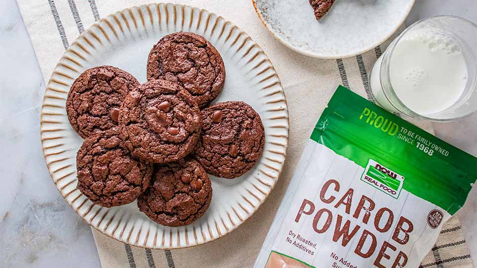 top view of carob brownie cookies next to bag of NOW Carbo powder