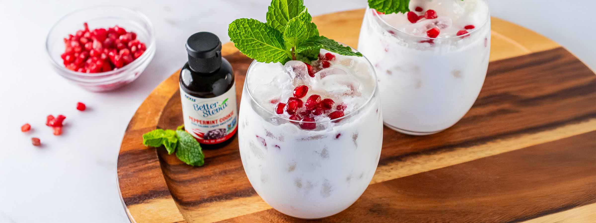 two glasses on Holiday Peppermint Cookie Mocktail next to a bottle of BetterStevia Peppermint Cookie