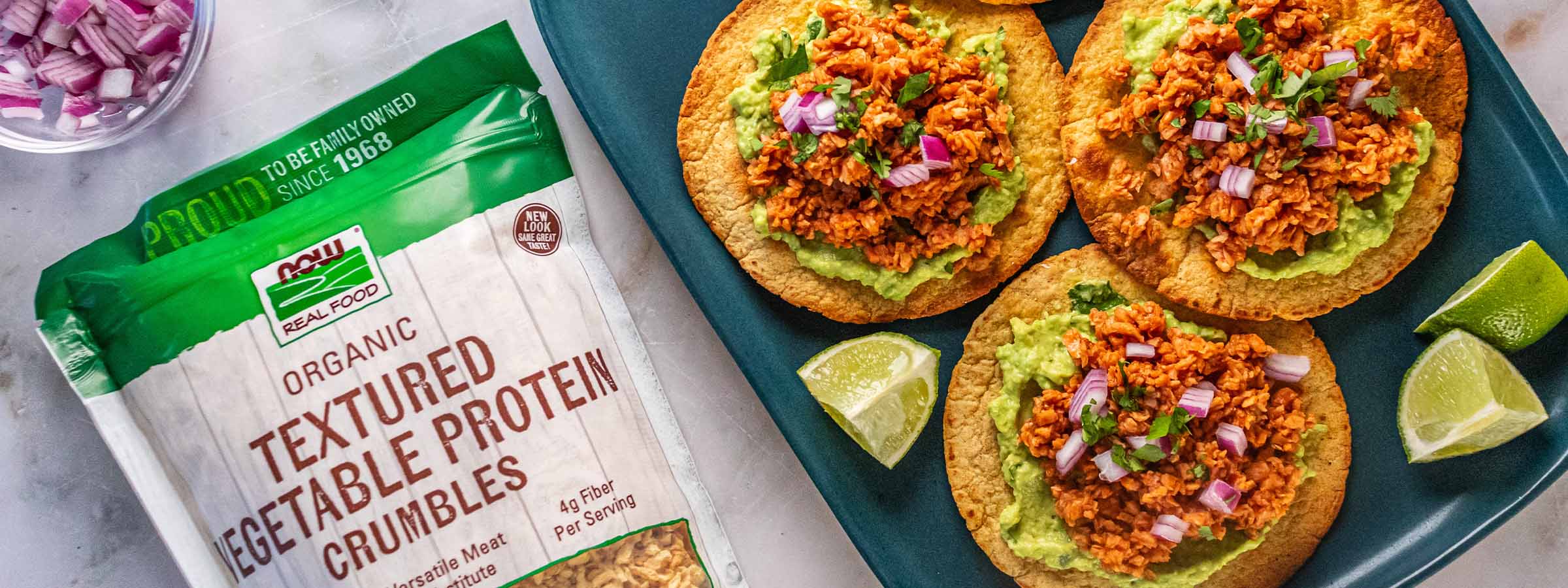 top view of Vegan Protein Tostadas next to a bag of NOW Textured vegetable crumbles