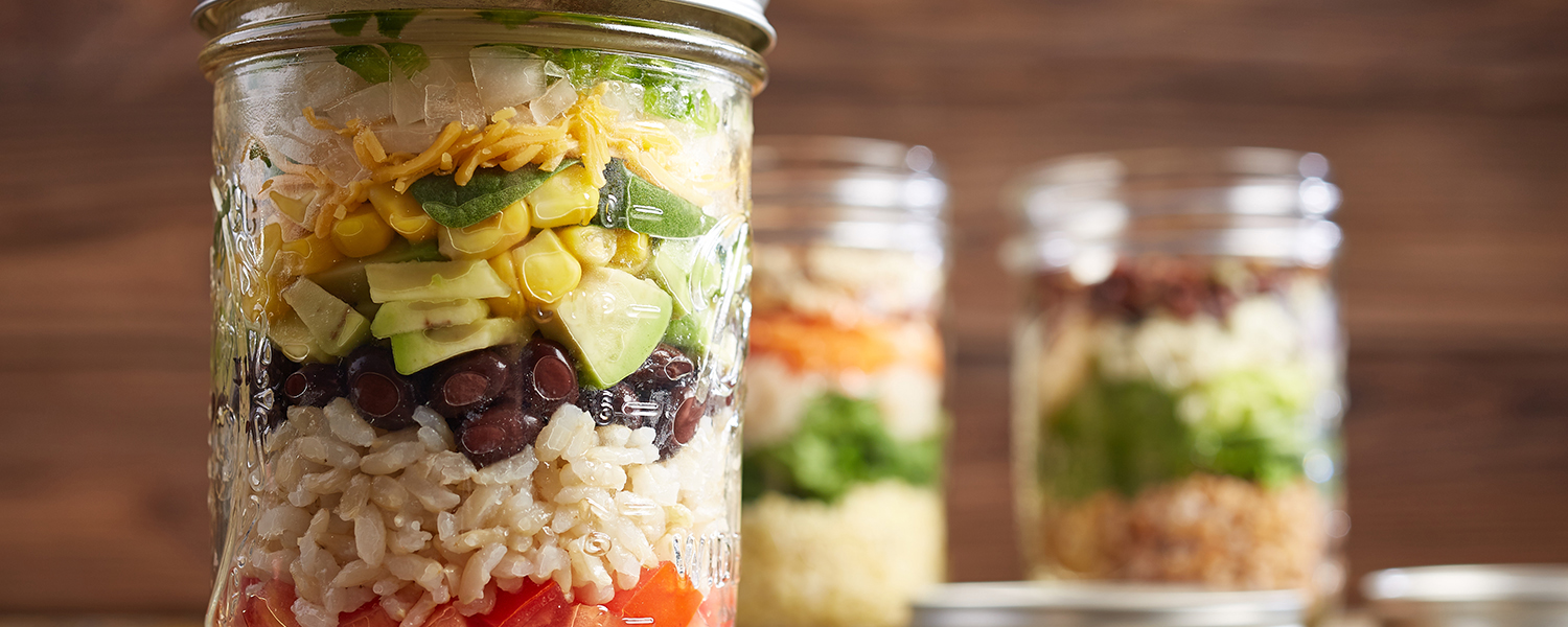 Several mason jars filled with Fiesta Mason Jar Salad