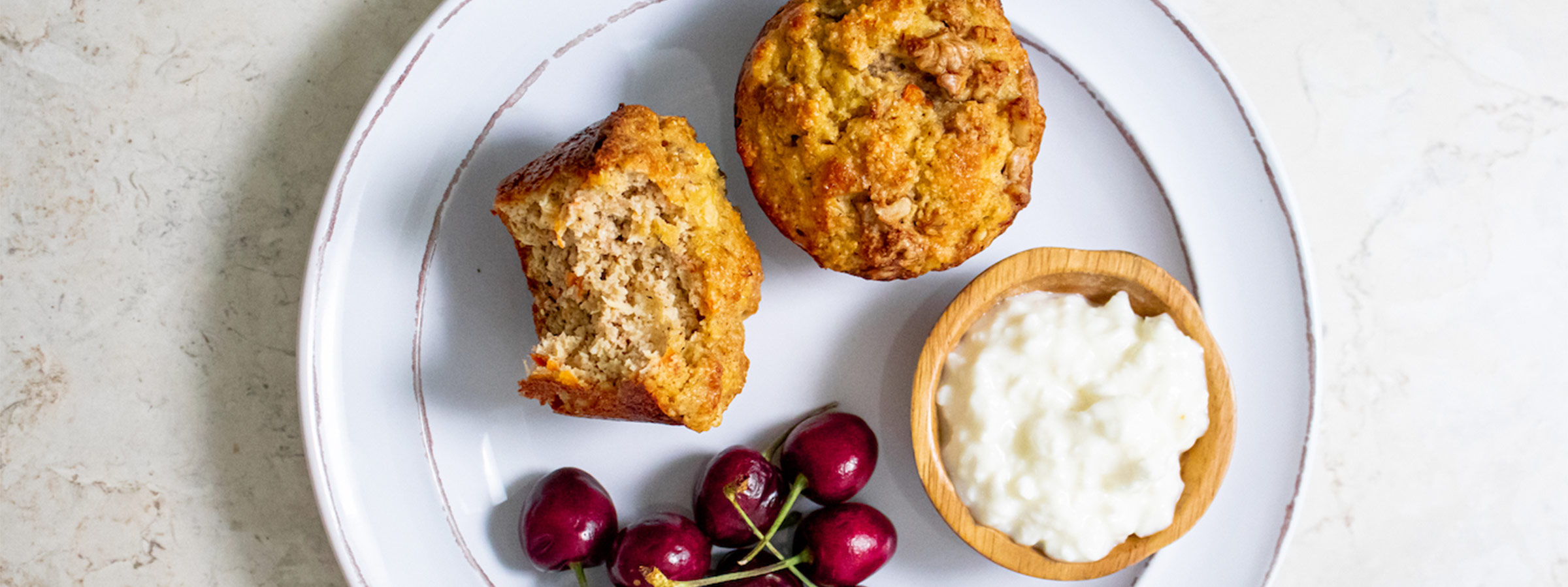 Morning Glory Muffins on a white plate with cherries