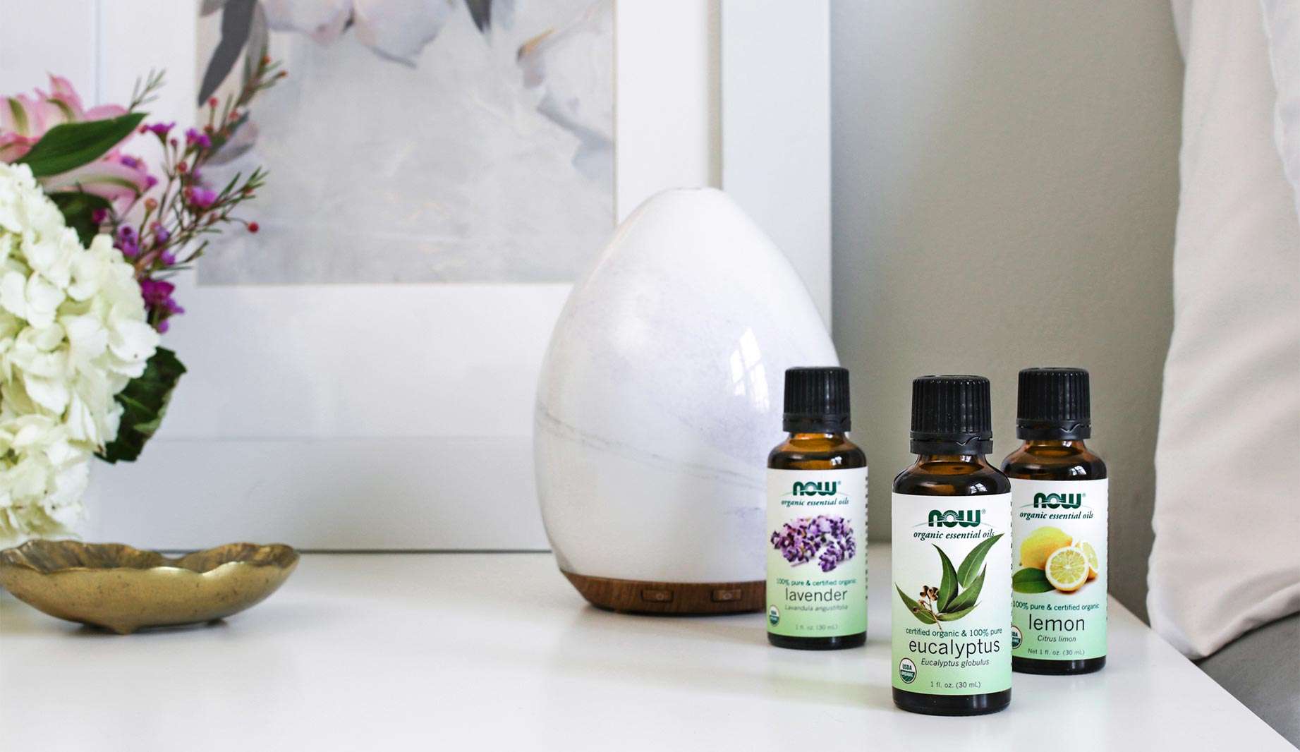 NOW Solutions Lavender, Eucalyptus, and Lemon Essential Oils on a counter with the Glass diffuser