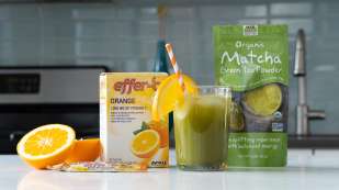 kitchen countertop with oranges, Effer-C box Matcha Tea Bag and glass of green drink with red and white stripped straw sticking out