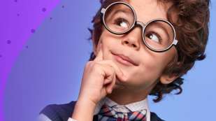 child with glasses looking off to the right finder to chin in a thinking stance.