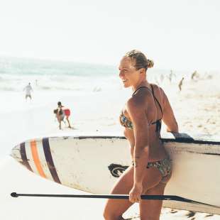 Candace Appleby carrying a Paddle board