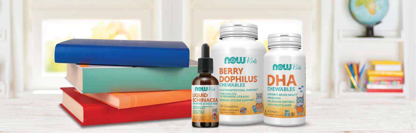 a stack of four books, a bottle of NOW Kid's Liquid Echenacea, a bottle of Kid's Berry Dophilus and a bottle of Kid's DHA Chewables all on a white table with white background