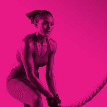 Women working out with a rope wearing fitness clothing
