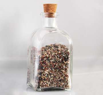 glass bottle with cork top filled with Triple Omega Seed Mix