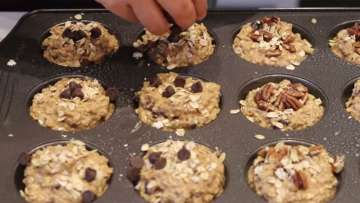 gray muffin pan with nine spots filled with oat cup mixture ready for the oven