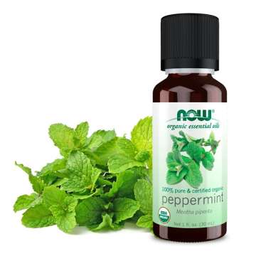 NOW Solutions Peppermint Oil with mint leaves behind the bottle