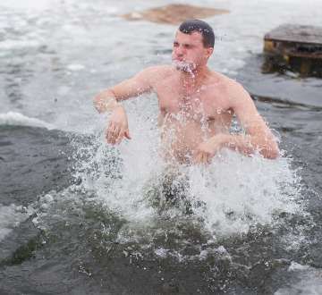 light skinned male presenting person jumping in ice water