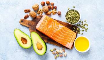 group of foods that represent Omega-3 including salmon, tuna, sardines, flaxseed oil, walnuts, seeds