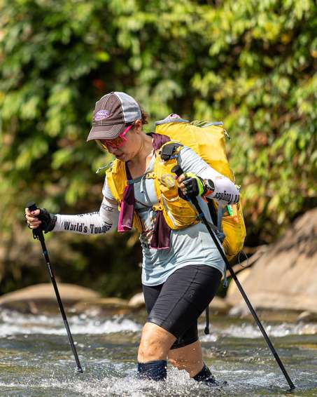 Rachel Belmont trekking through water
