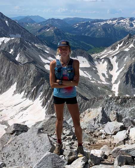Erin Ton standing on a mountain 