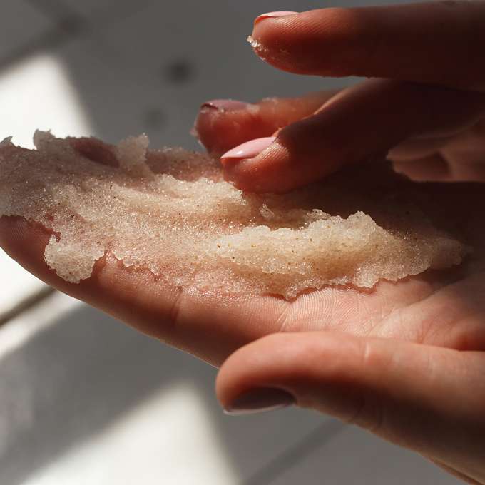 Sugar scrub in light skinned hands
