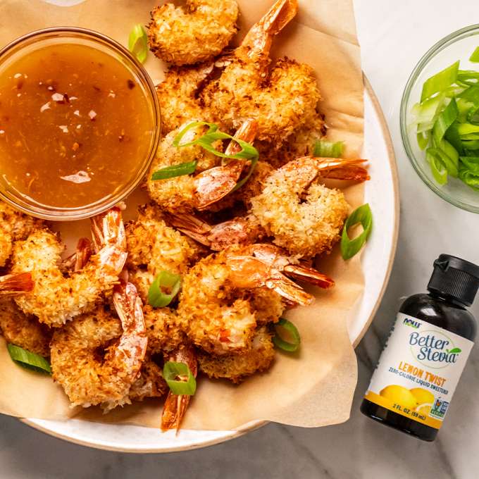 Top view of air fired coconut shrimp with bottle of lemon twist better stevia