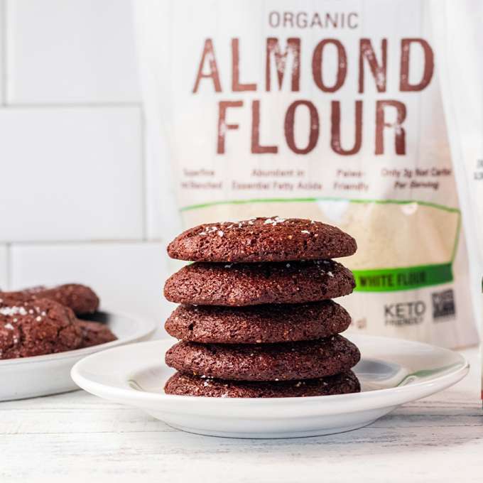 white plate containing stack of double chocolate peppermint cookies next to better stevia peppermint cookie liquid