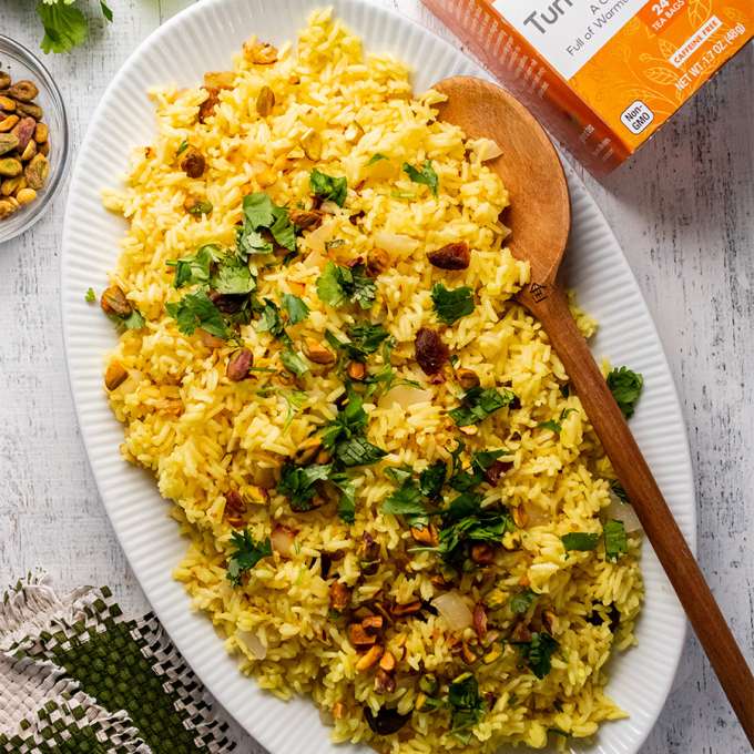top view of Turmeric Ginger Moroccan Rice next to a box of NOW Tumeric tea