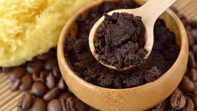 top view of coffee scrub in wooden bowl with small wooden spoon