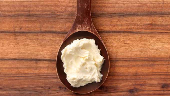 A wooden spoon of sugar cookie body butter