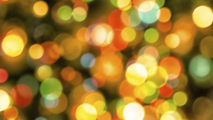 Lens flares of multiple colors against a dark background.