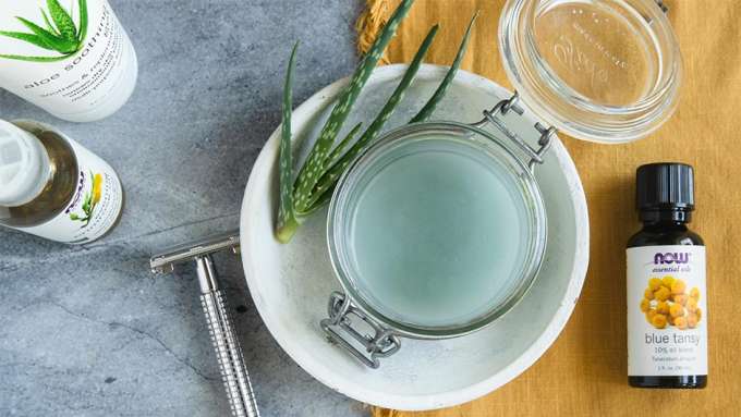 Glass Jar with Lid open with Light blue Shave Gel inside. bottle of NOW blue tansy essential oil, Bottle of Aloe Soothing Gel and bottle of Evening Primrose oil 