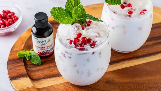 two glasses on Holiday Peppermint Cookie Mocktail next to a bottle of BetterStevia Peppermint Cookie