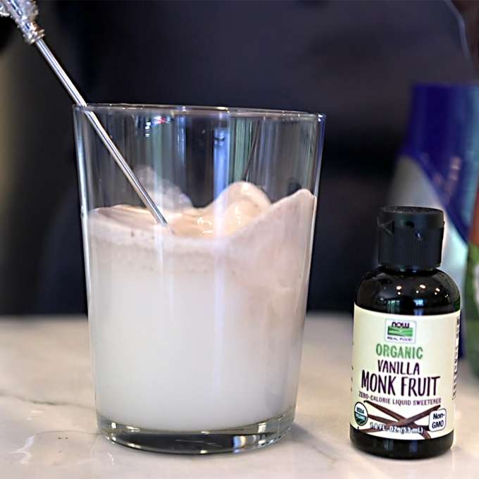 glass of horchata next to NOW Essential Oils Organic Vanilla Monk Fruit Liquid