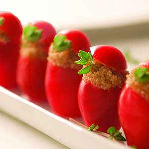 A closeup of several Organic Amaranth-Stuffed Cherry Tomatoes.