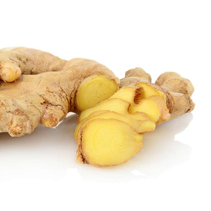 A sliced open ginger root placed on a white counter.