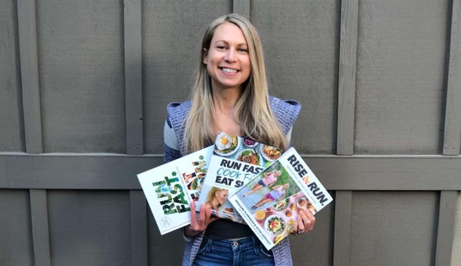 Elyse Kopecky holding her 3 recipe books