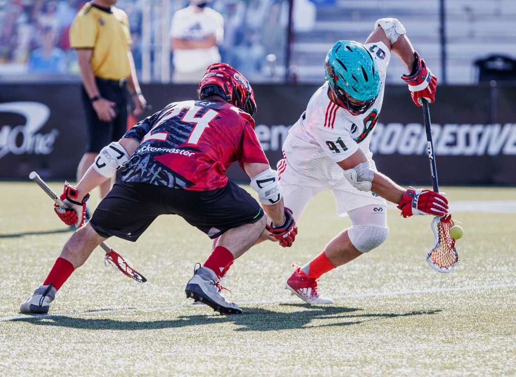 Joe Nardella playing lacrosse with a defender close by