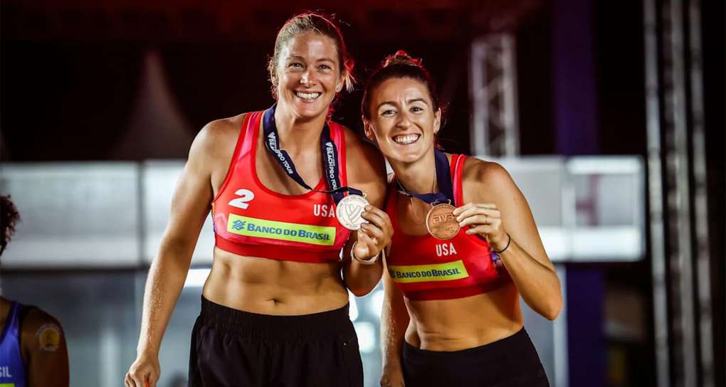 Kim Hildreth and teammate holding a winning metals