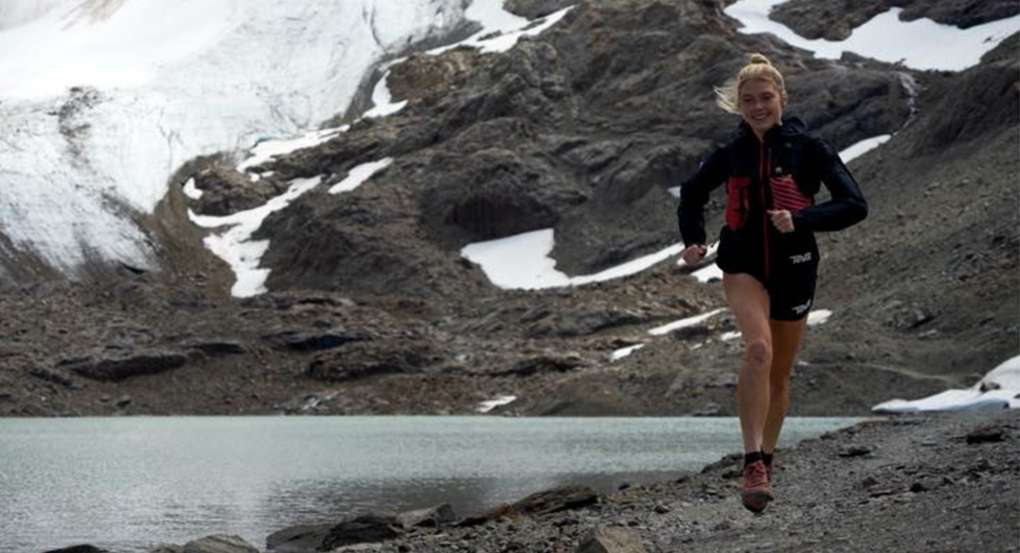 Erin Ton Running on a Mountain next to a lake